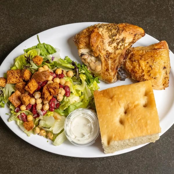Roasted chicken with rosemary, a side salad with chickpeas and croutons, focaccia bread, and ranch dressing.